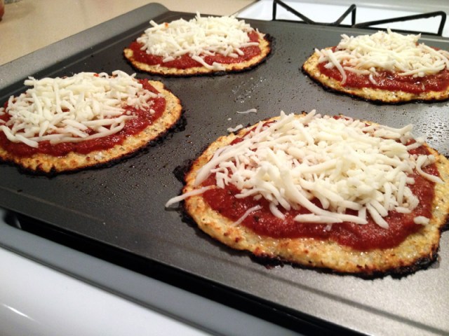 cooked cauliflower crust with tomato sauce and cheese2