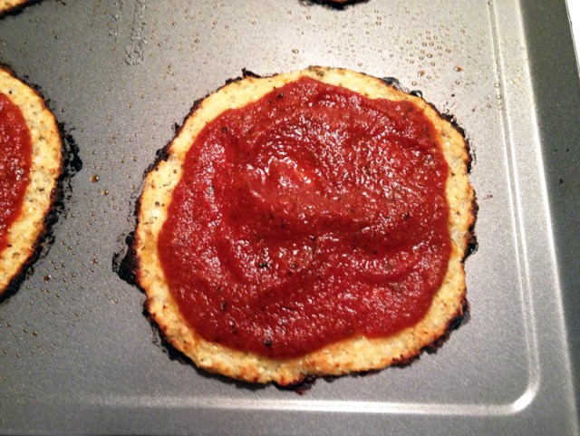 cooked cauliflower crust with tomato sauce close up